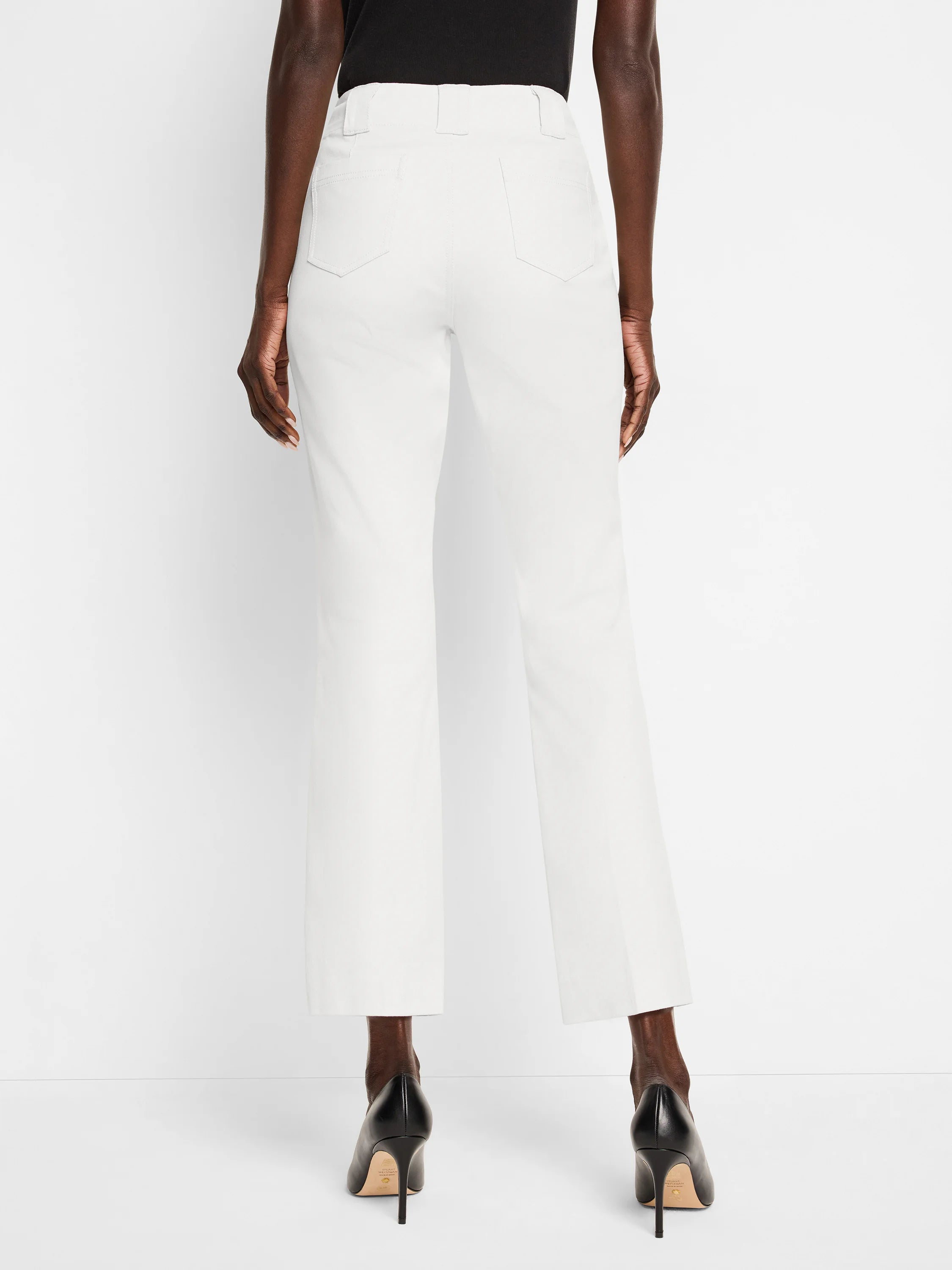 White demi boot pants, rear view. Features belt loops, two back patch pockets, and a cropped length.
