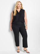 Black demi bootcut pants with a slim fit, subtle flare at the ankle, and cropped length.