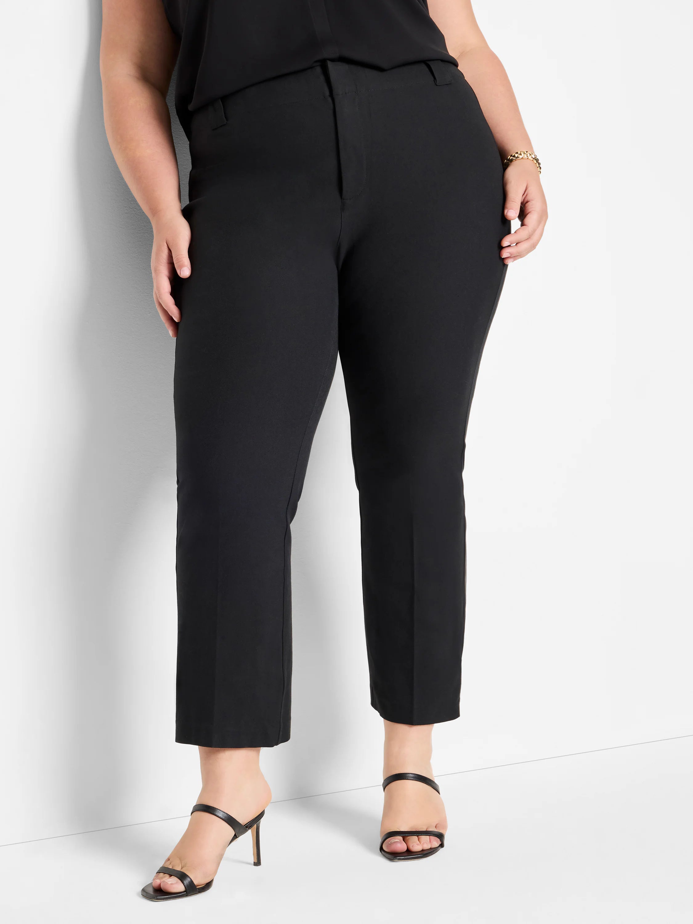 Black tailored bi-stretch pants on model. Cropped length with a straight-leg and flat front.