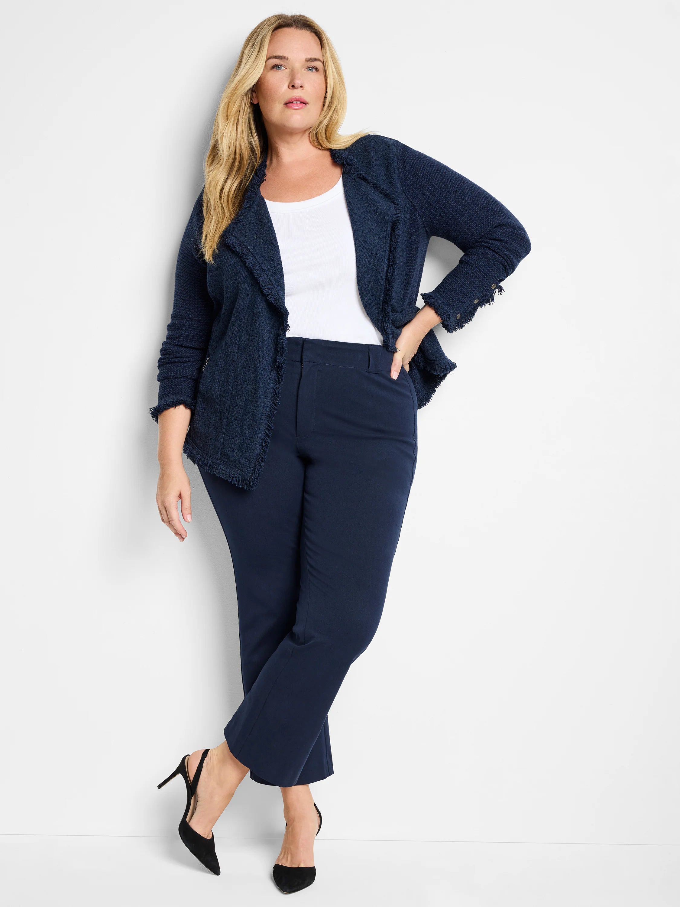 Dark blue demi boot-cut pants. Smooth bi-stretch fabric, slim through leg, cropped ankle hem. Flat-front waist with belt...