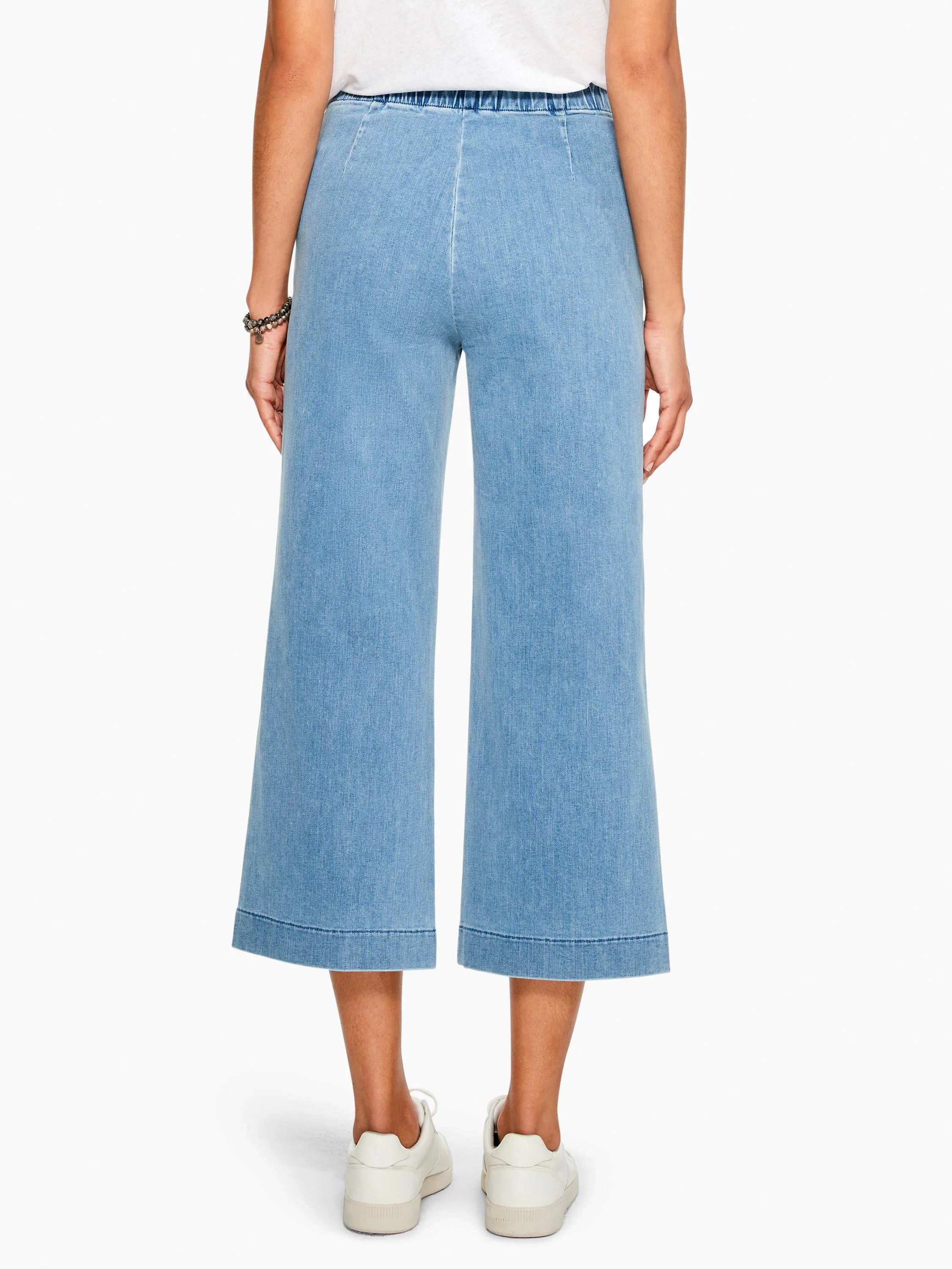 Here's alt text for the image, following all specifications:
Light blue, wide-leg cropped jeans with an elastic...