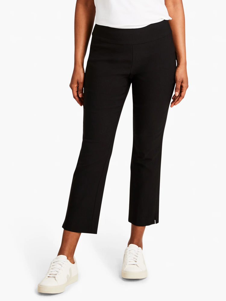 Black straight-leg cropped pants, mid-rise waist, slight side slits at hem. Model wears white sneakers.