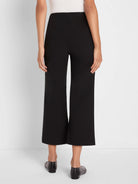 Black polished wide-leg crop pants, above-ankle length.