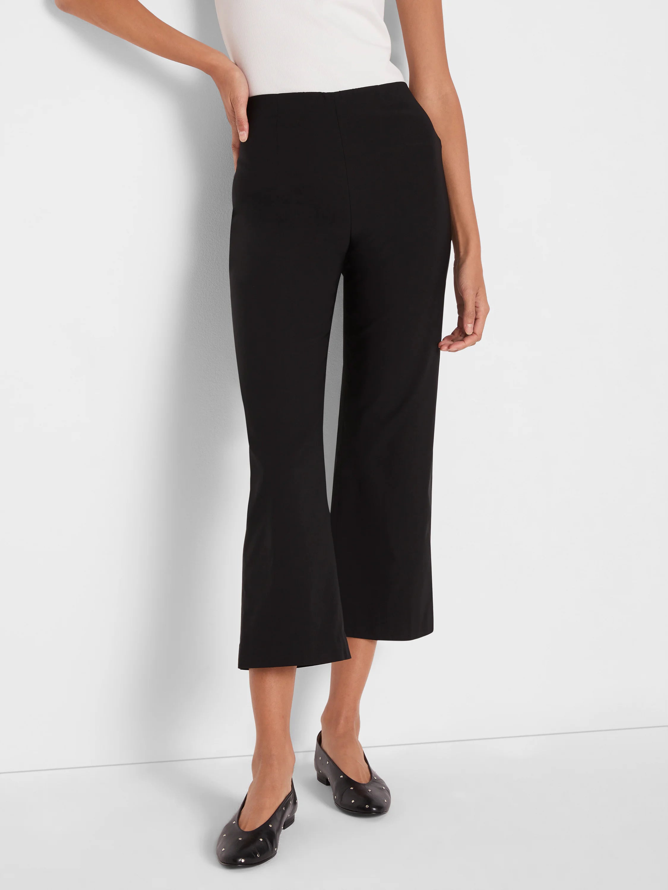 Black wide-leg crop pants, high-waisted, with a smooth fabric texture, ending mid-calf.