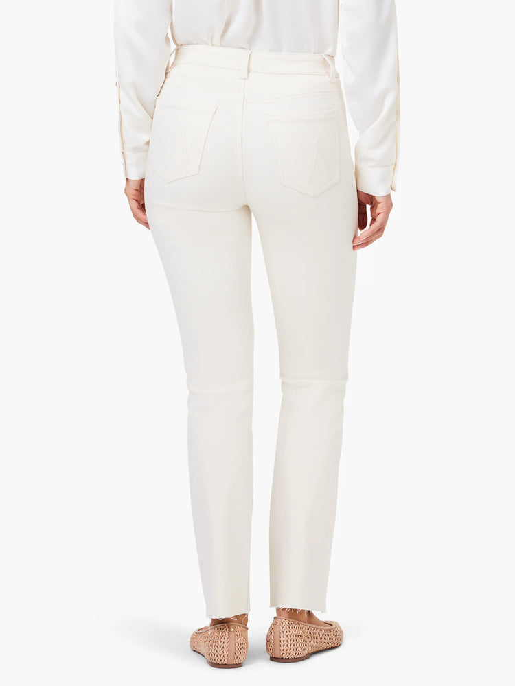 Ecru straight ankle jeans, shown from the back, featuring back pockets with subtle stitching and frayed raw hems.