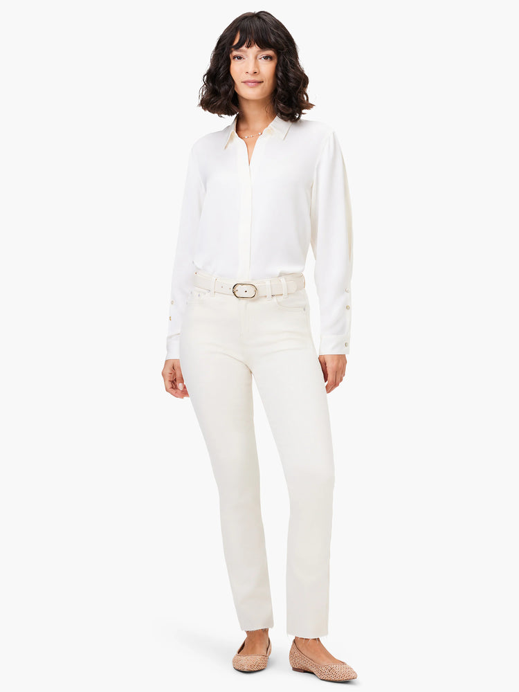 Ecru straight ankle jeans with a raw, frayed hem on a model.