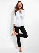 Black straight leg pants, cropped to the ankle, worn by a model.