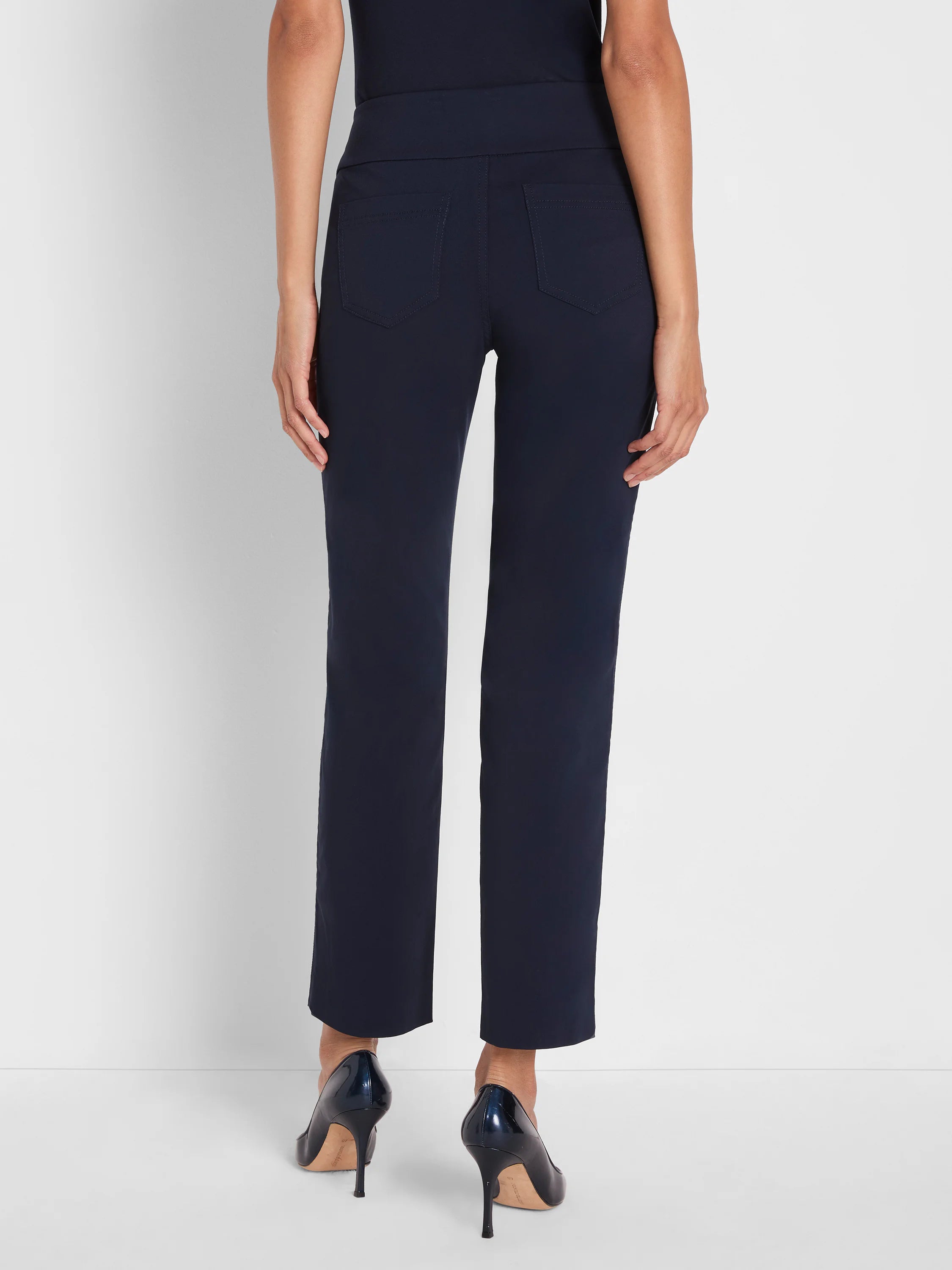 Navy straight leg pull-on pants with wide elastic waistband and two back patch pockets, shown from rear.