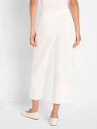 Cream wide-leg cropped jeans on a model from behind, showing an elasticated waist.