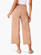 Rear view of light brown wide leg cropped jeans with an elasticized waist.