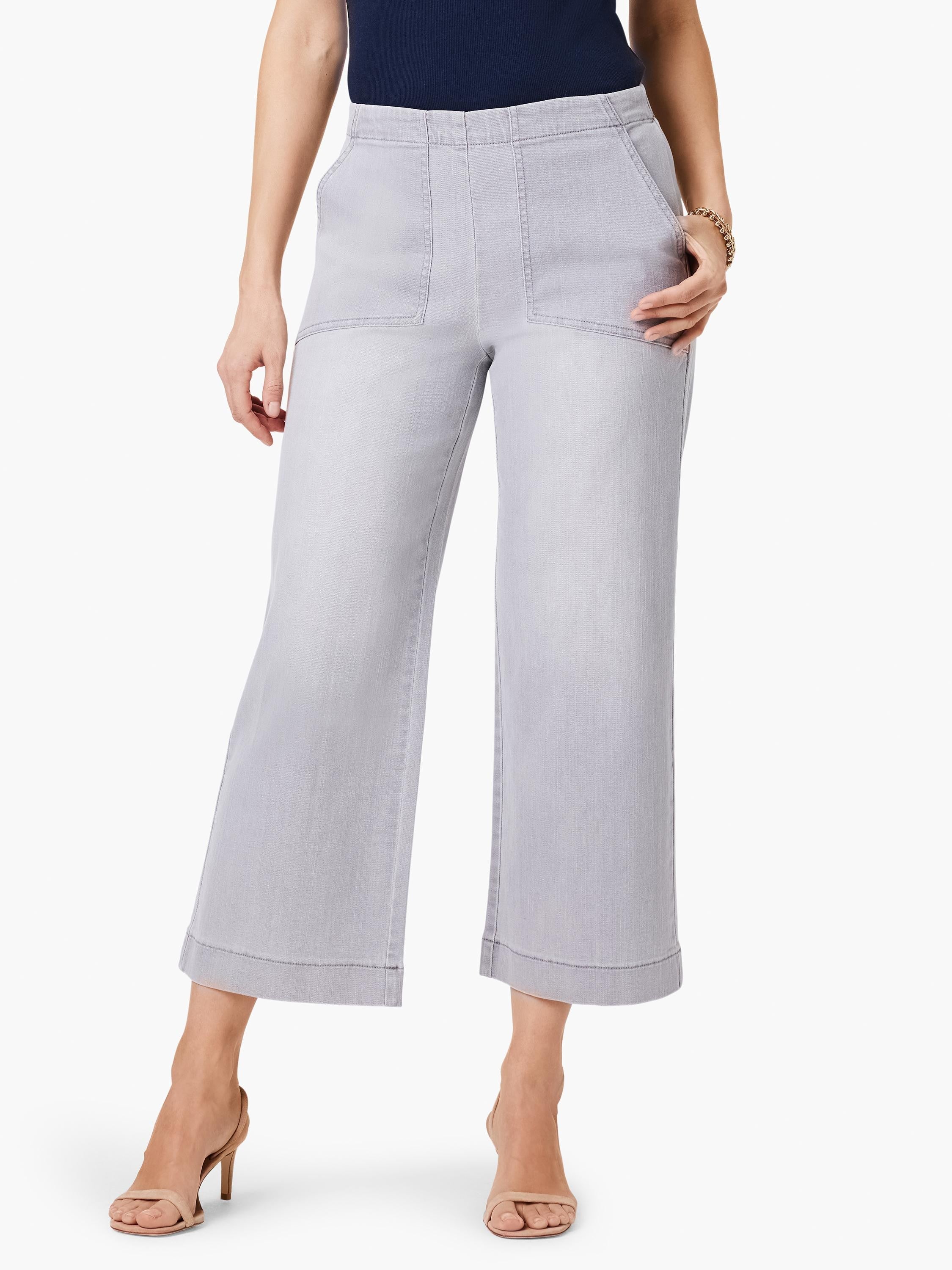 Light grey wide-leg cropped jeans with large front patch pockets and distinct vertical front seams.