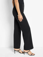 Black wide-leg trousers, full length, with smooth fabric.