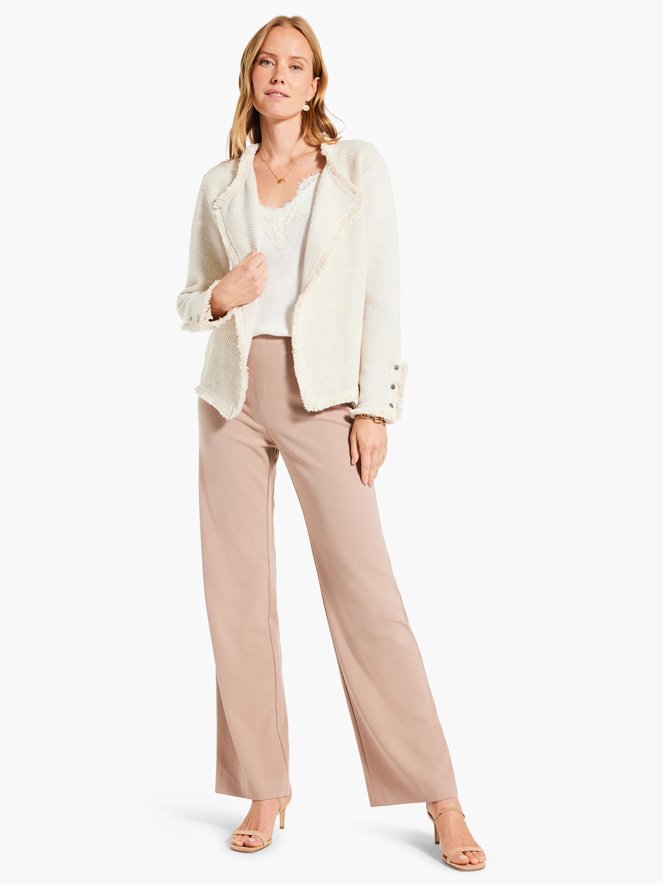 Pale beige wide leg trousers with smooth fabric, full length on model.
