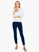 Deep indigo slim jeans, ankle-length, form-fitting from hip to ankle.