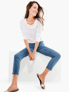 Medium blue, slim-fit jeans with subtle thigh fading. Tapered leg and a slightly cropped length.