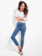 Medium blue slim fit jeans with visible front seam details below the waist.