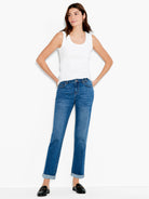 Medium blue wash denim jeans with a mid-rise, straight leg, subtle fading, and cuffed hems.