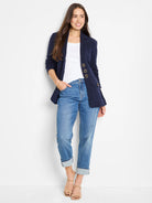 Medium blue wash mid-rise girlfriend jeans, relaxed fit, cuffed at ankles.