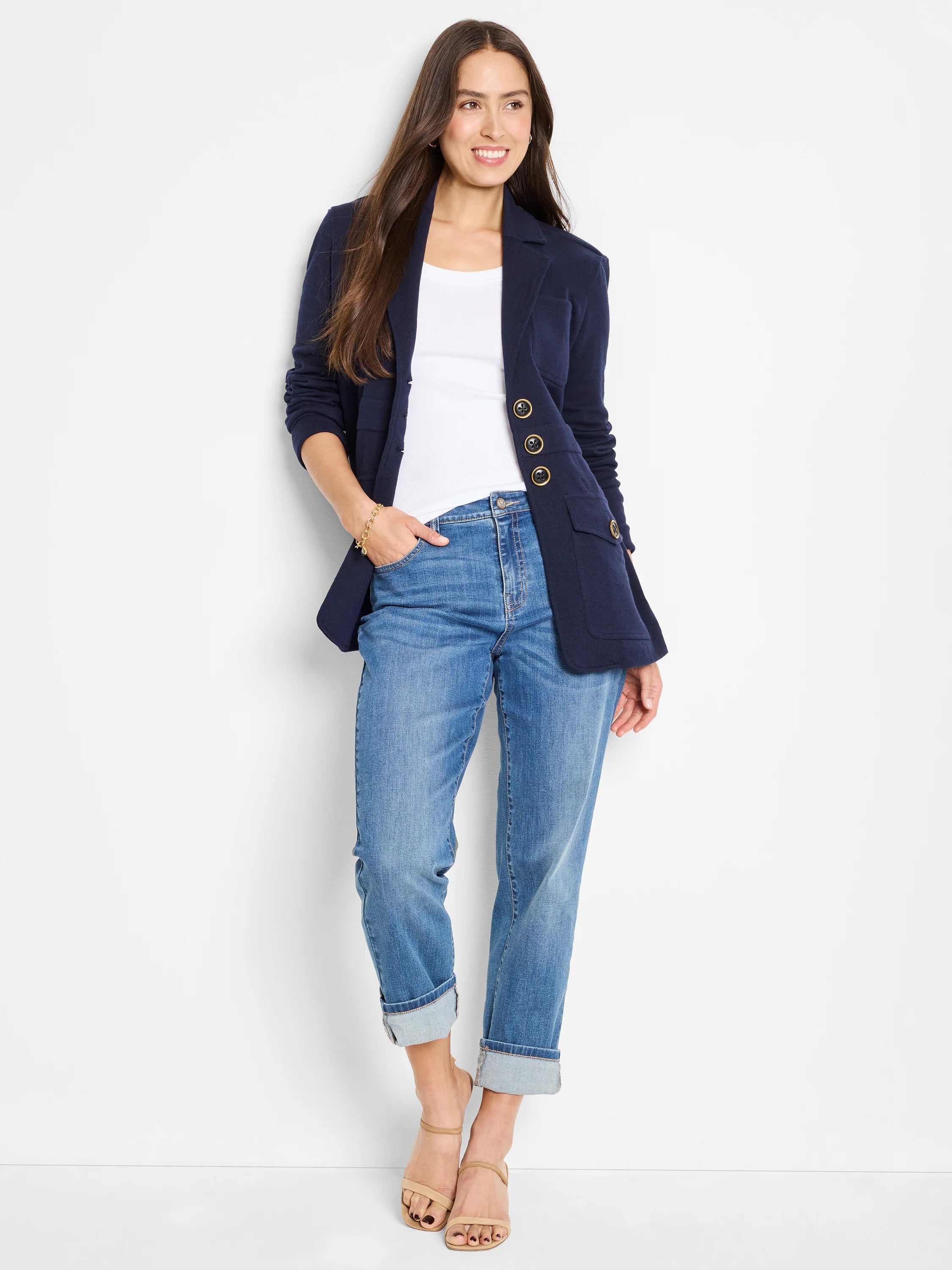 Medium blue wash mid-rise girlfriend jeans, relaxed fit, cuffed at ankles.