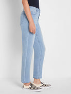 Light wash blue jeans, mid-rise, with a relaxed straight leg fit that crops at the ankle. Features front pockets and belt...