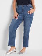 Medium blue mid-rise girlfriend jeans with a relaxed, slightly cropped leg and classic denim details.