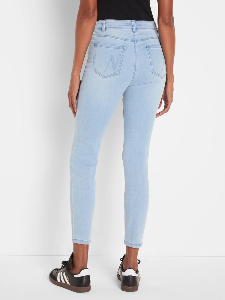 Light blue slim ankle jeans, back view. Faded denim, mid-rise, with back pockets and subtle arc stitching on right pocket.