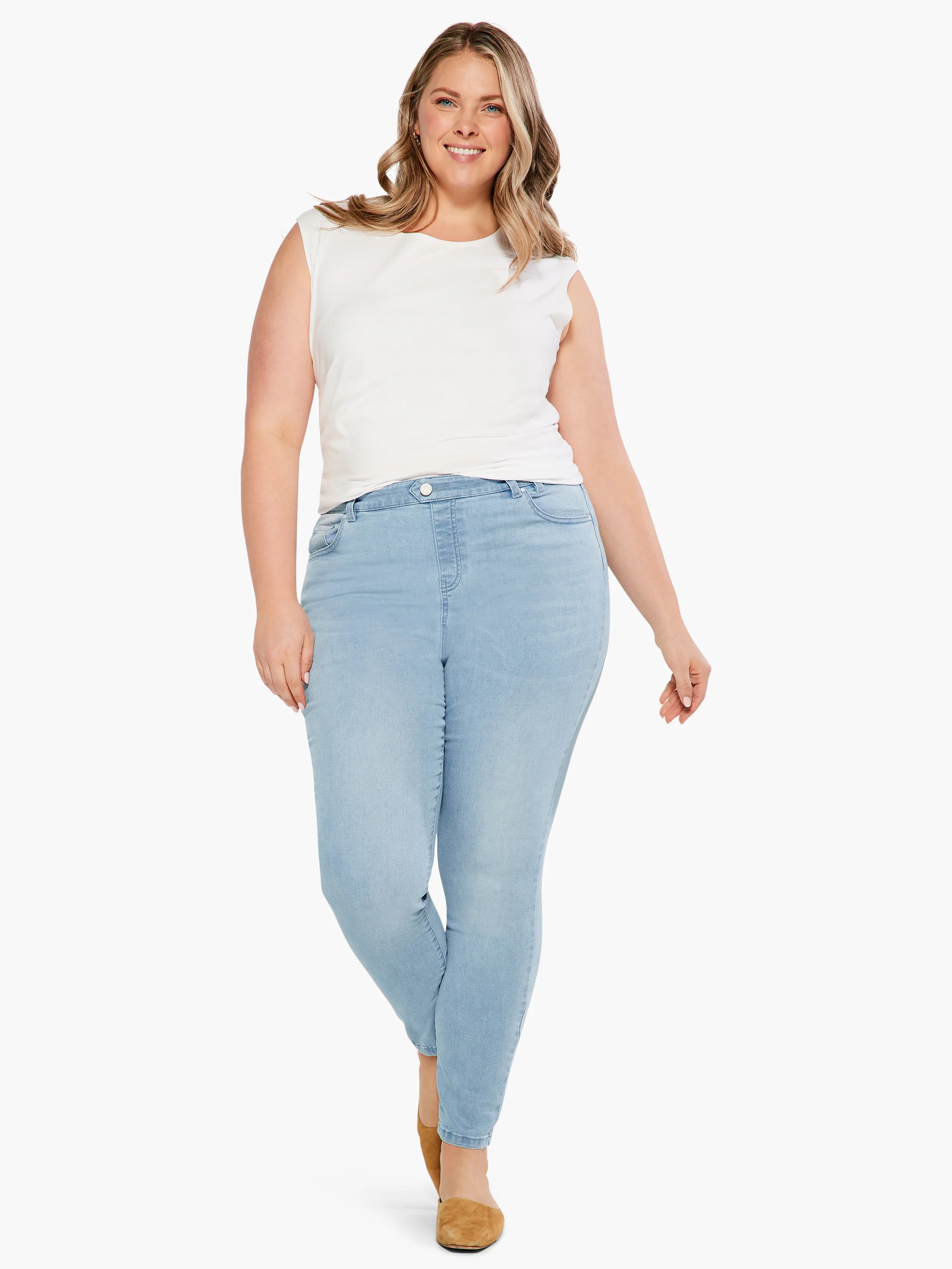 Light blue, mid-rise slim ankle jeans on a model.
