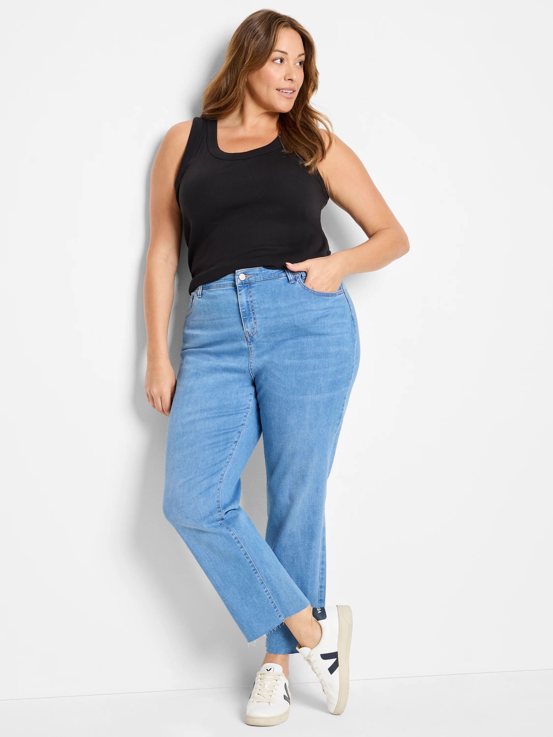 Light blue straight ankle jeans with a raw, frayed hem.