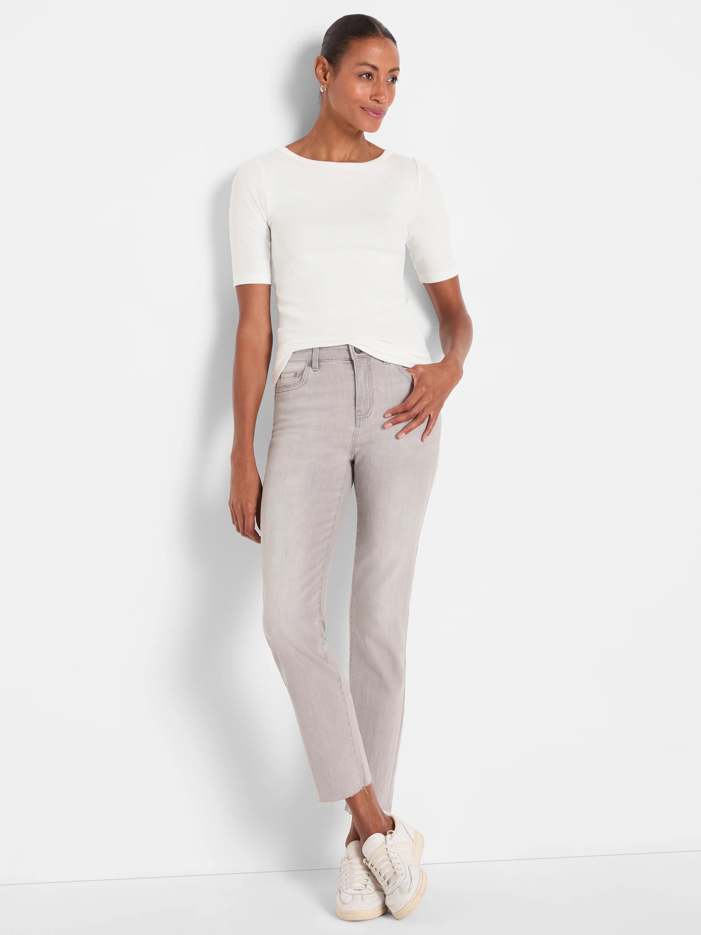Pale grey straight ankle jeans with a frayed hem.