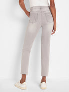 Back view of high-waisted, washed light gray straight ankle jeans with frayed hems.
