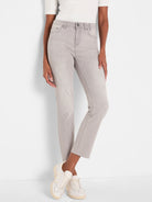 Light gray straight ankle jeans with a frayed hem. Worn by a person from the waist down.