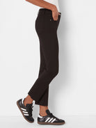 Black straight ankle jeans with a raw, frayed hem, front and back pockets, and a subtle rhinestone detail.