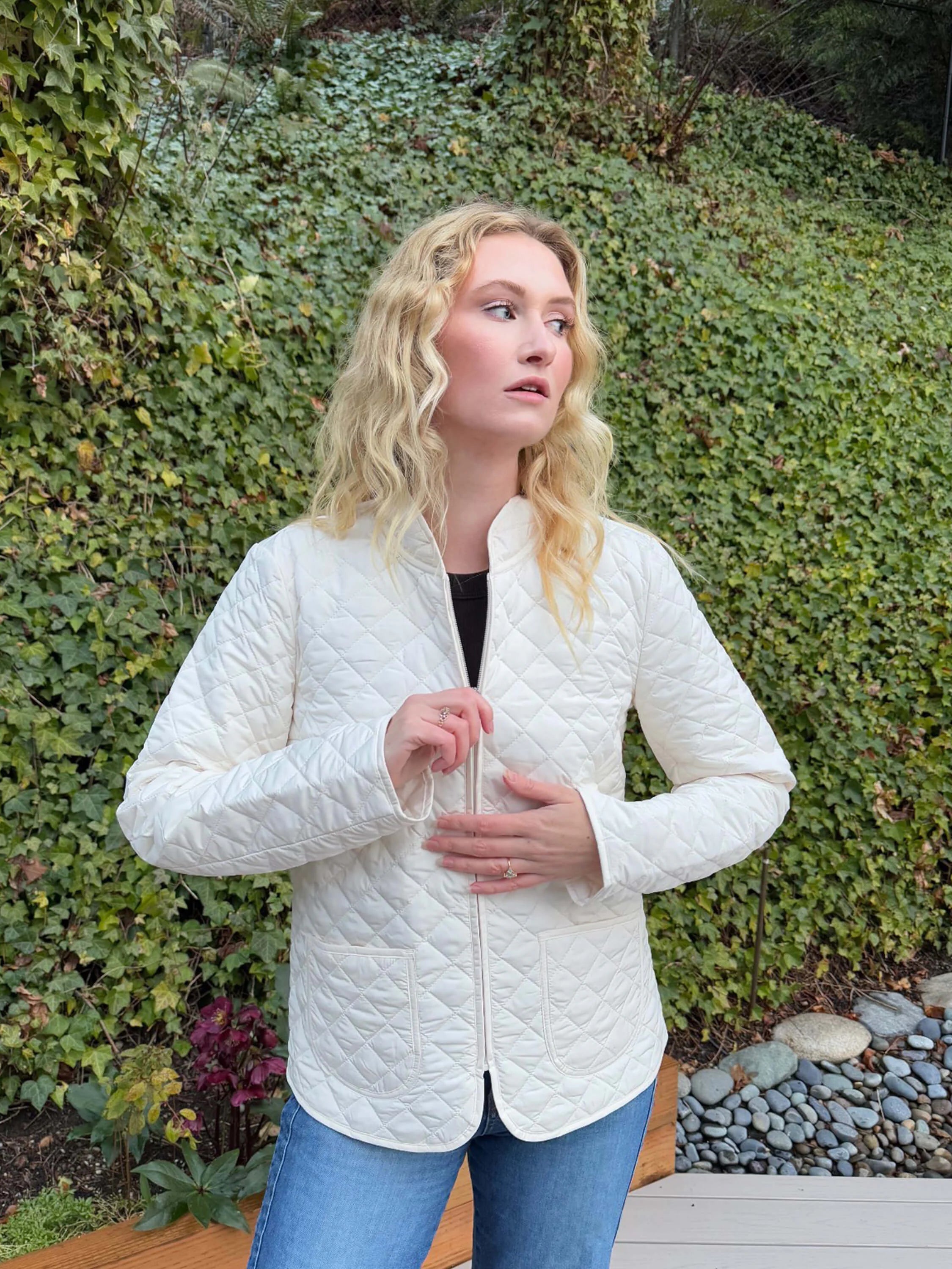 Off-white quilted short coat, diamond pattern. Front zipper. Patch pockets.