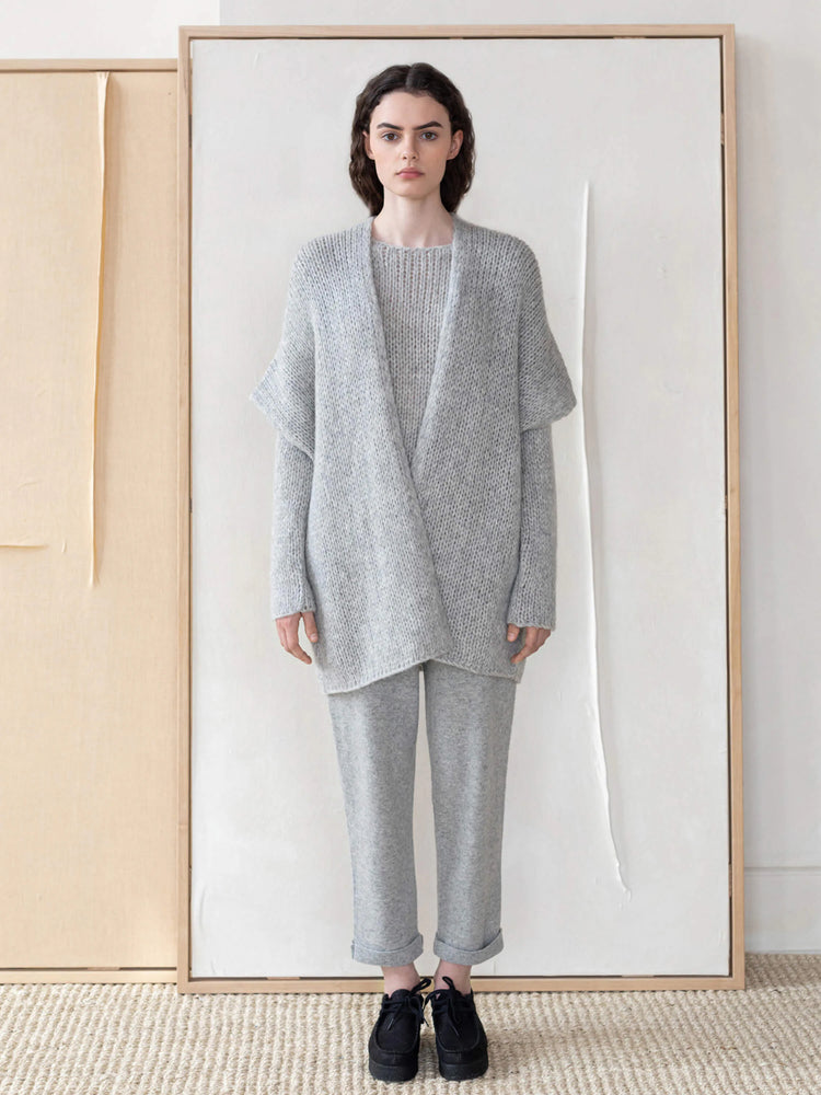 Light gray, loosely knit, open-front vest. Relaxed fit, slightly dolman sleeves.