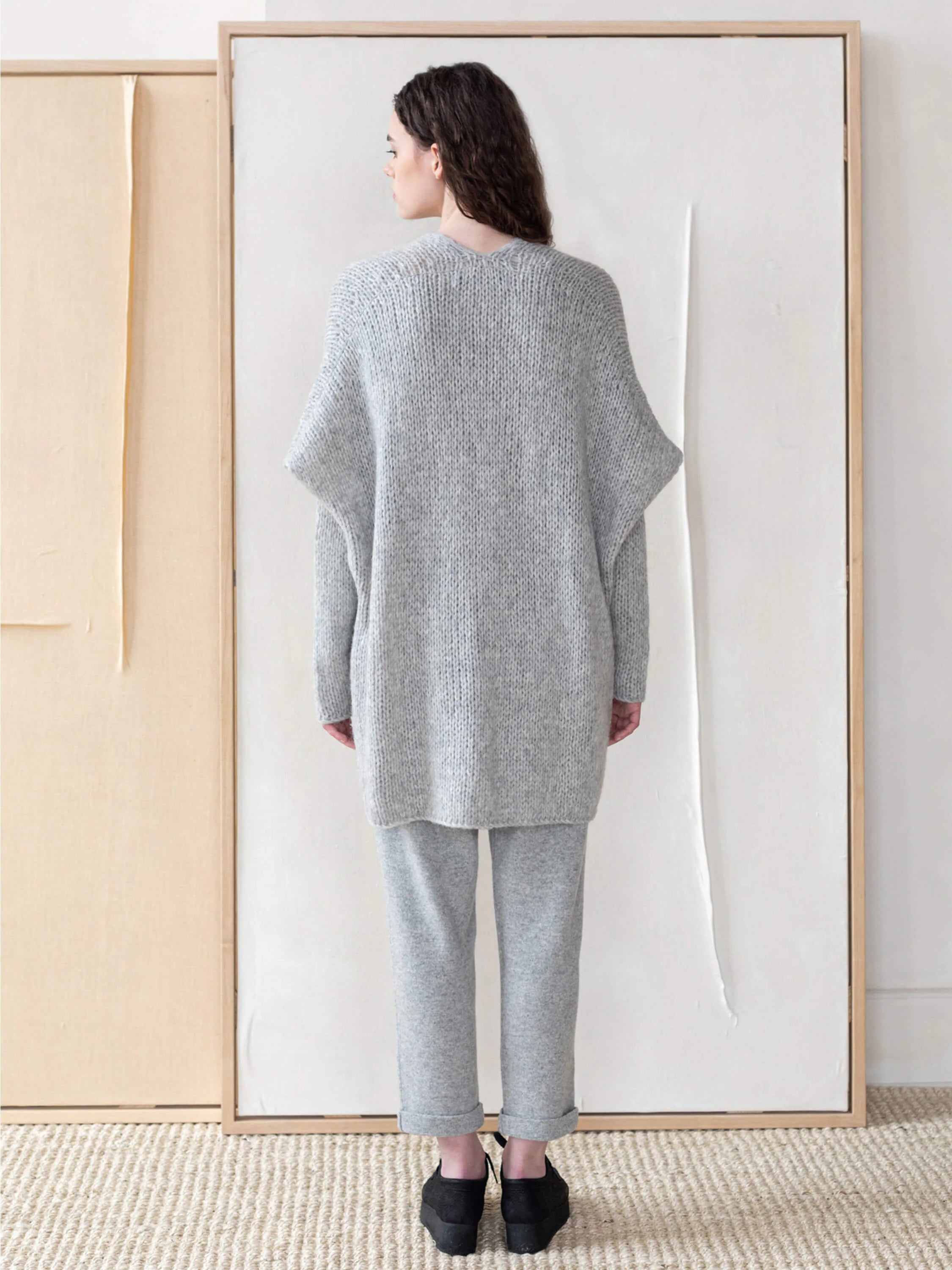 Light gray, oversized knit vest; long sleeves, relaxed fit.