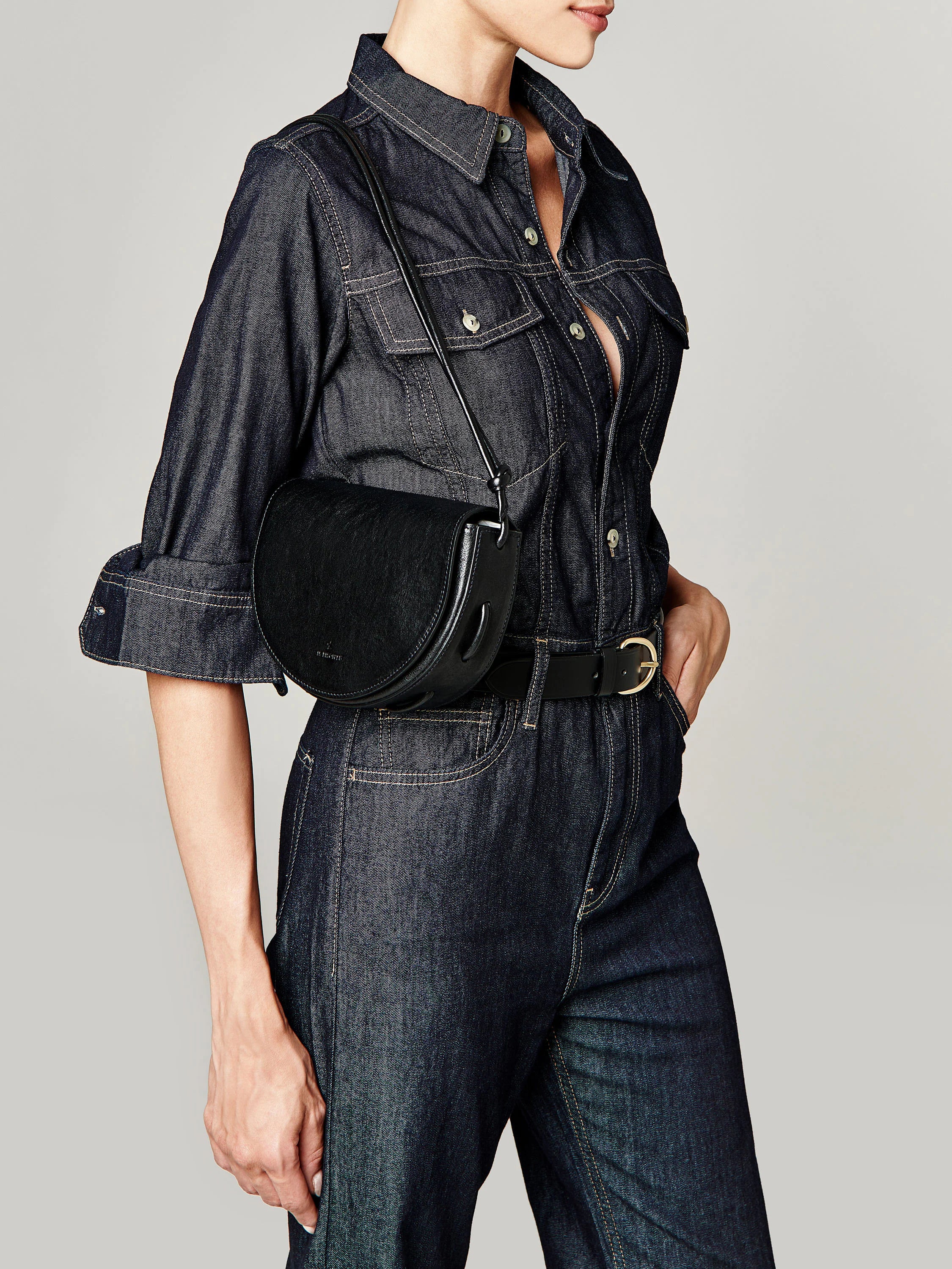 Black half-moon crossbody bag with a short strap. The bag has a slightly textured surface.