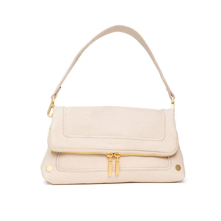 Textured cream leather shoulder bag with a fold-over flap, front gold zipper, and gold hardware.