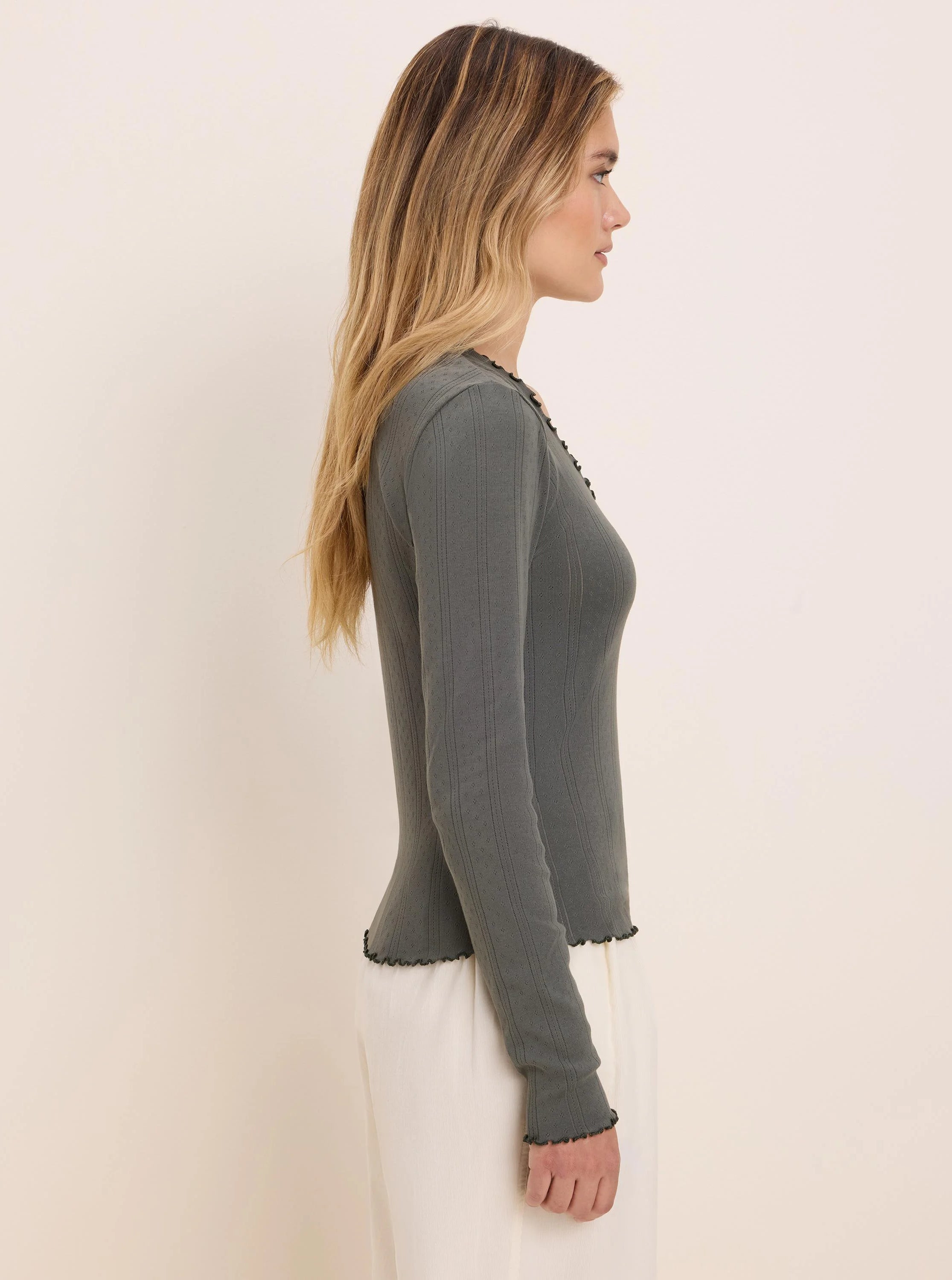 Dark green pointelle ribbed long sleeve tee with scalloped edges at neck, cuffs, and hem.