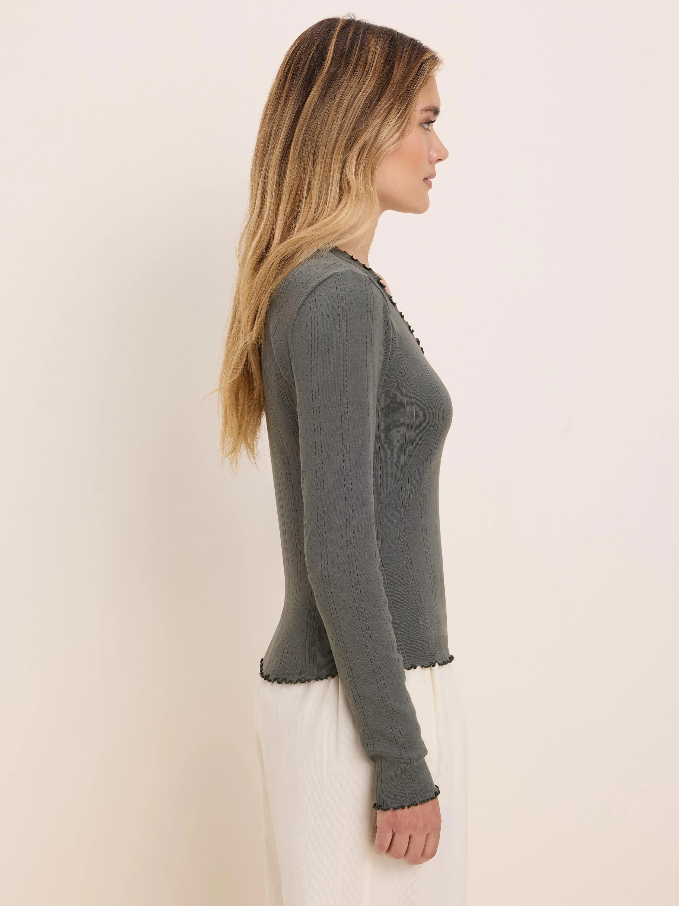 Dark green pointelle ribbed long sleeve tee with scalloped edges at neck, cuffs, and hem.
