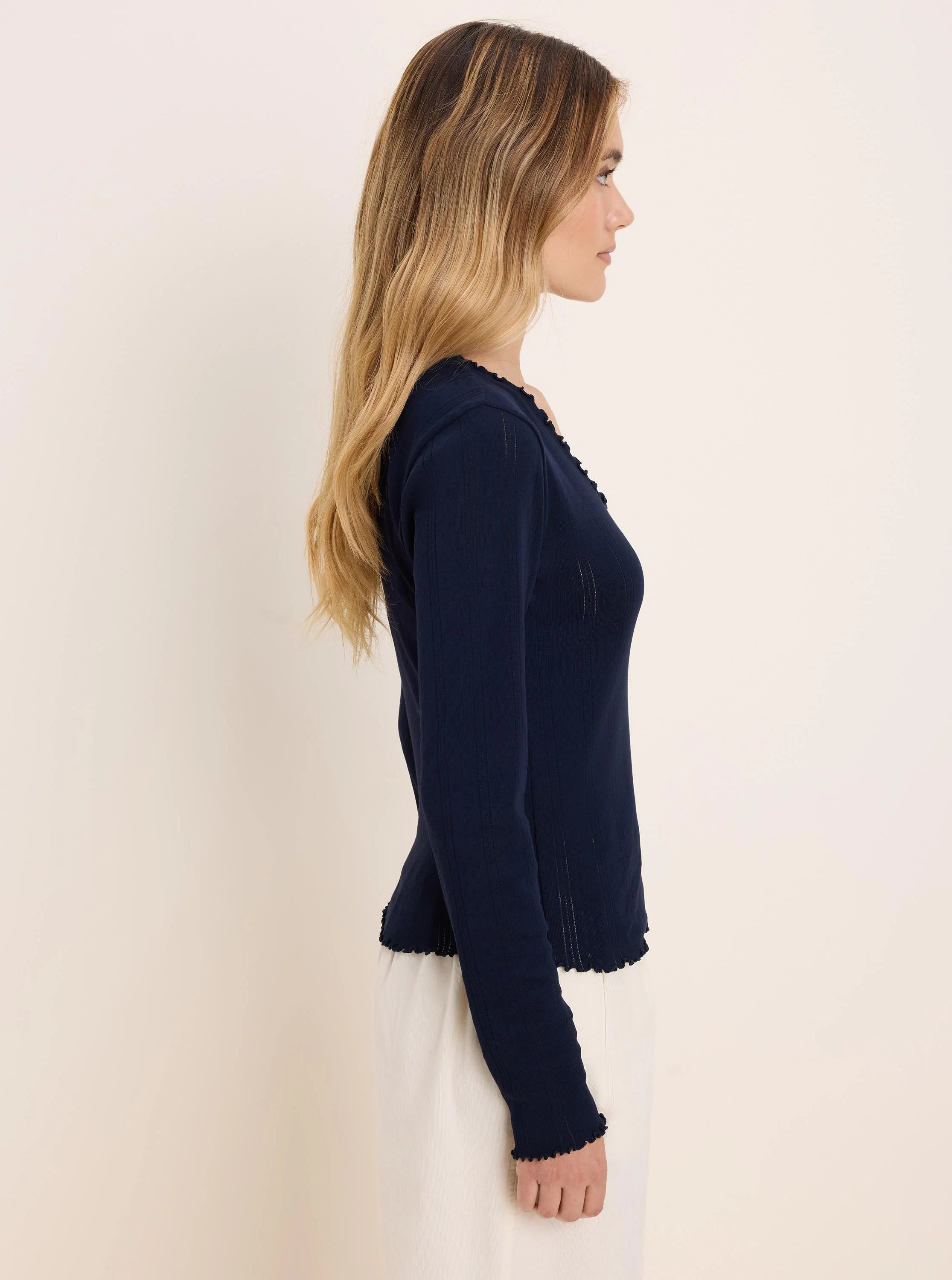 Navy pointelle rib long sleeve tee with lettuce-edge trim on the neckline, cuffs, and hem.