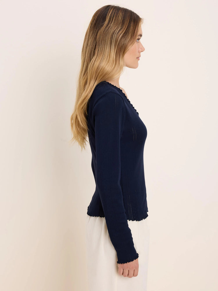 Navy pointelle rib long sleeve tee with lettuce-edge trim on the neckline, cuffs, and hem.