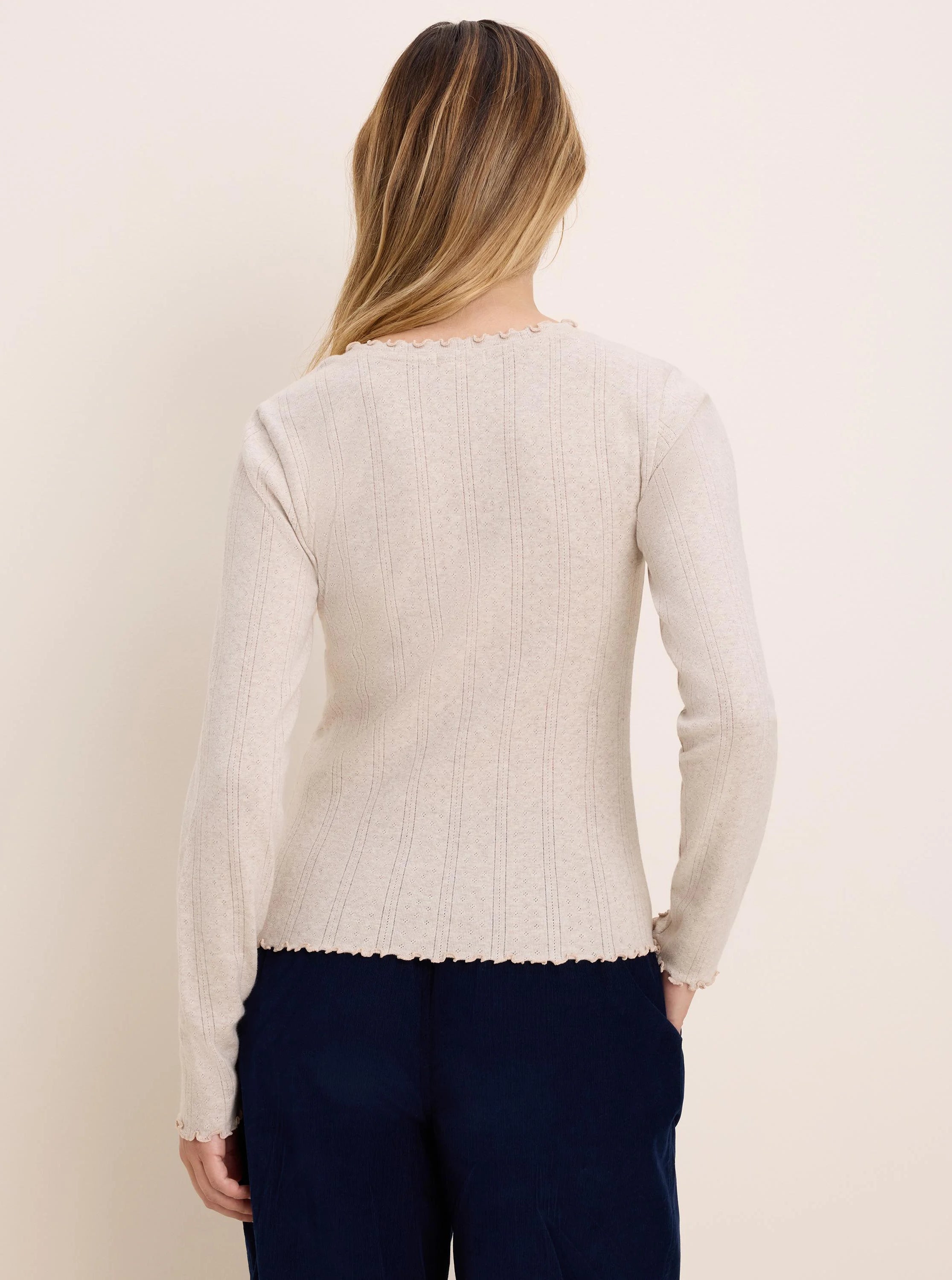 Light beige pointelle rib long sleeve tee, with wavy trim at neck and hem, viewed from back.