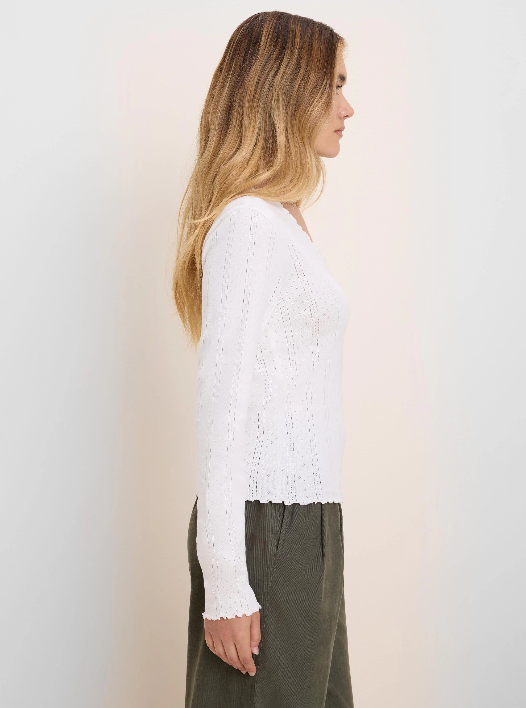 White pointelle rib long sleeve tee with square neckline, textured small holes, and ruffled cuffs/hem.