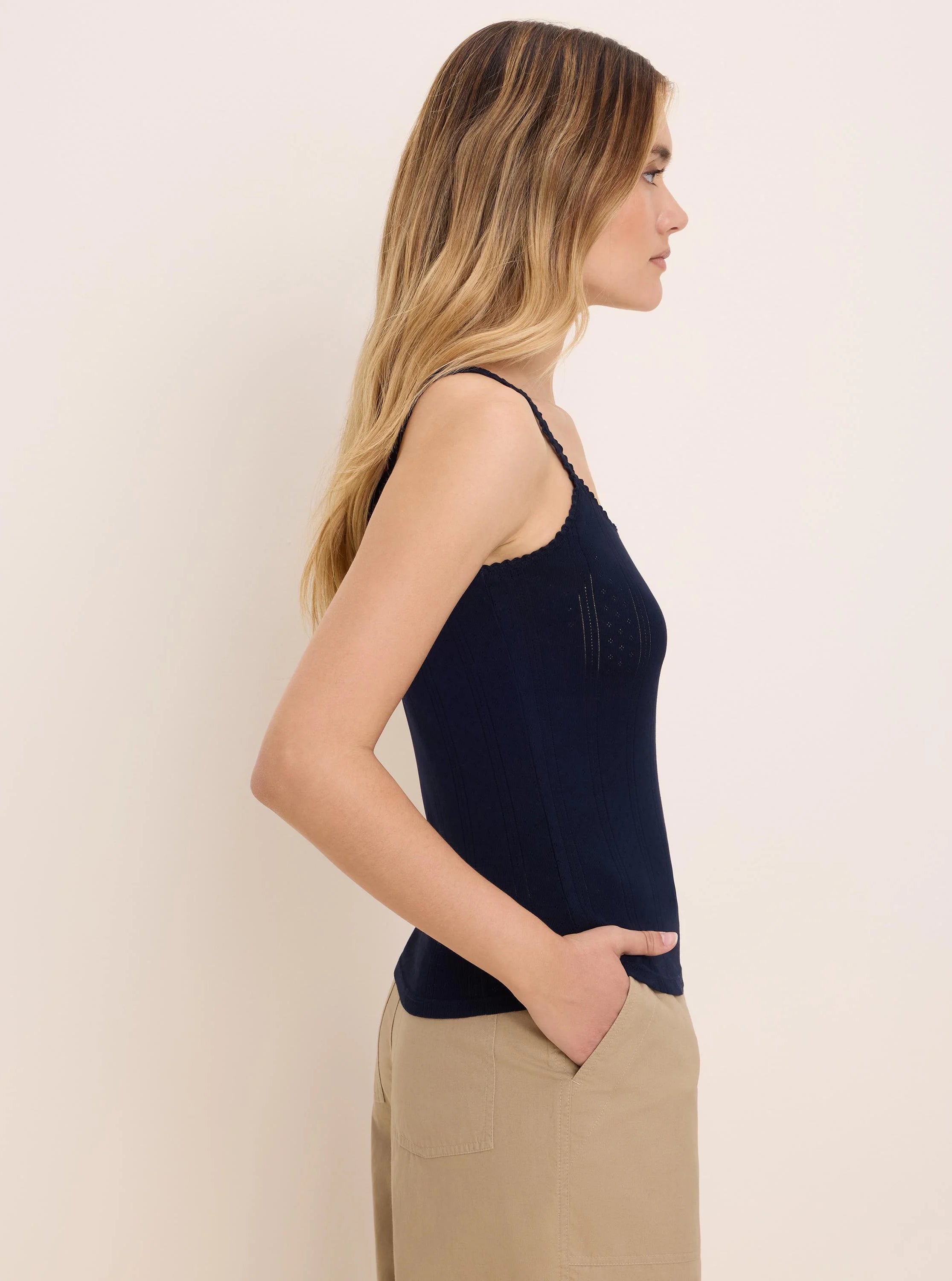 Navy pointelle rib cami with scalloped trim and spaghetti straps.