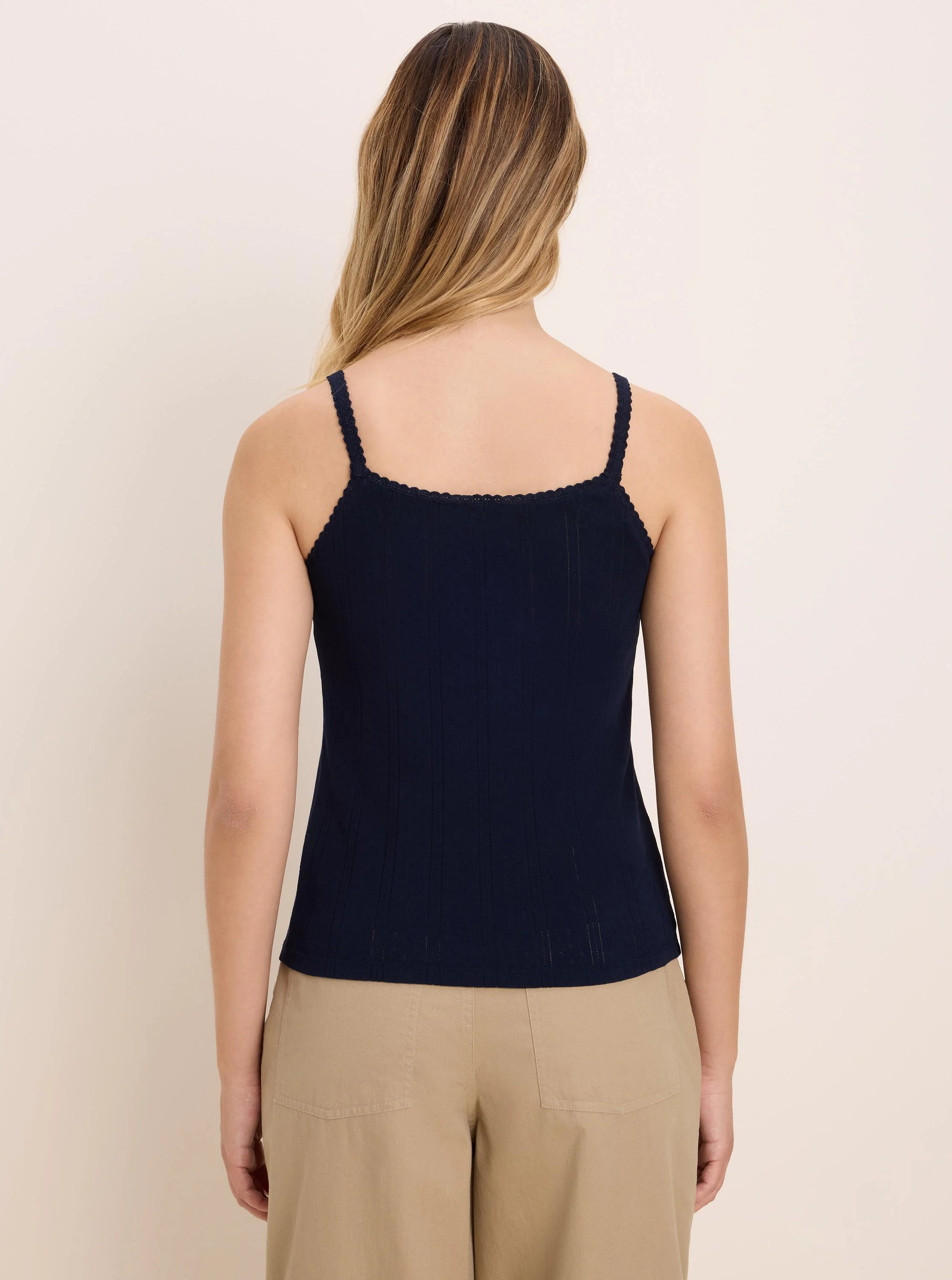Navy blue pointelle rib cami with scalloped spaghetti straps and back neckline, shown on a model from behind.