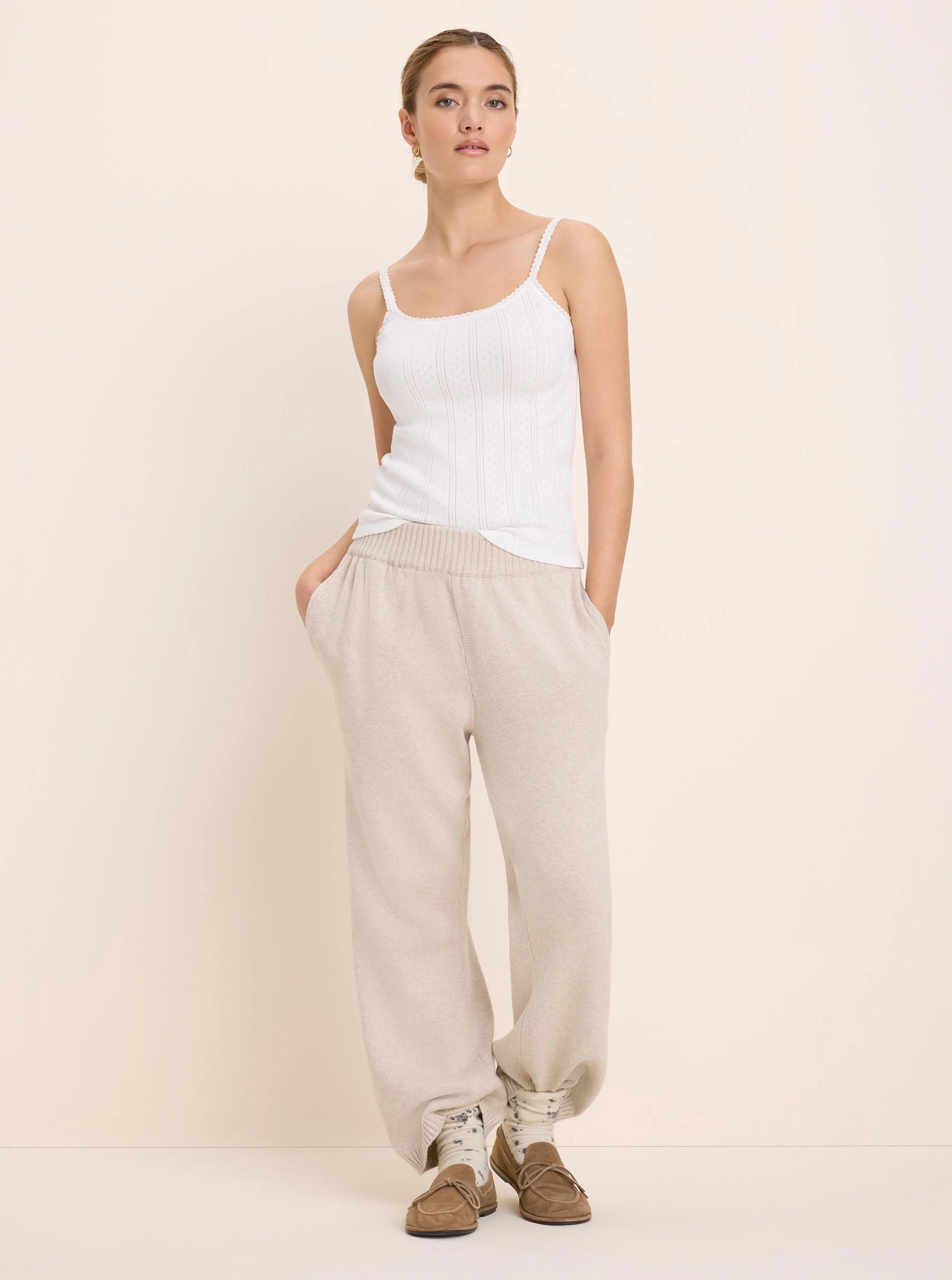White pointelle rib camisole with thin straps and delicate trim on neckline.