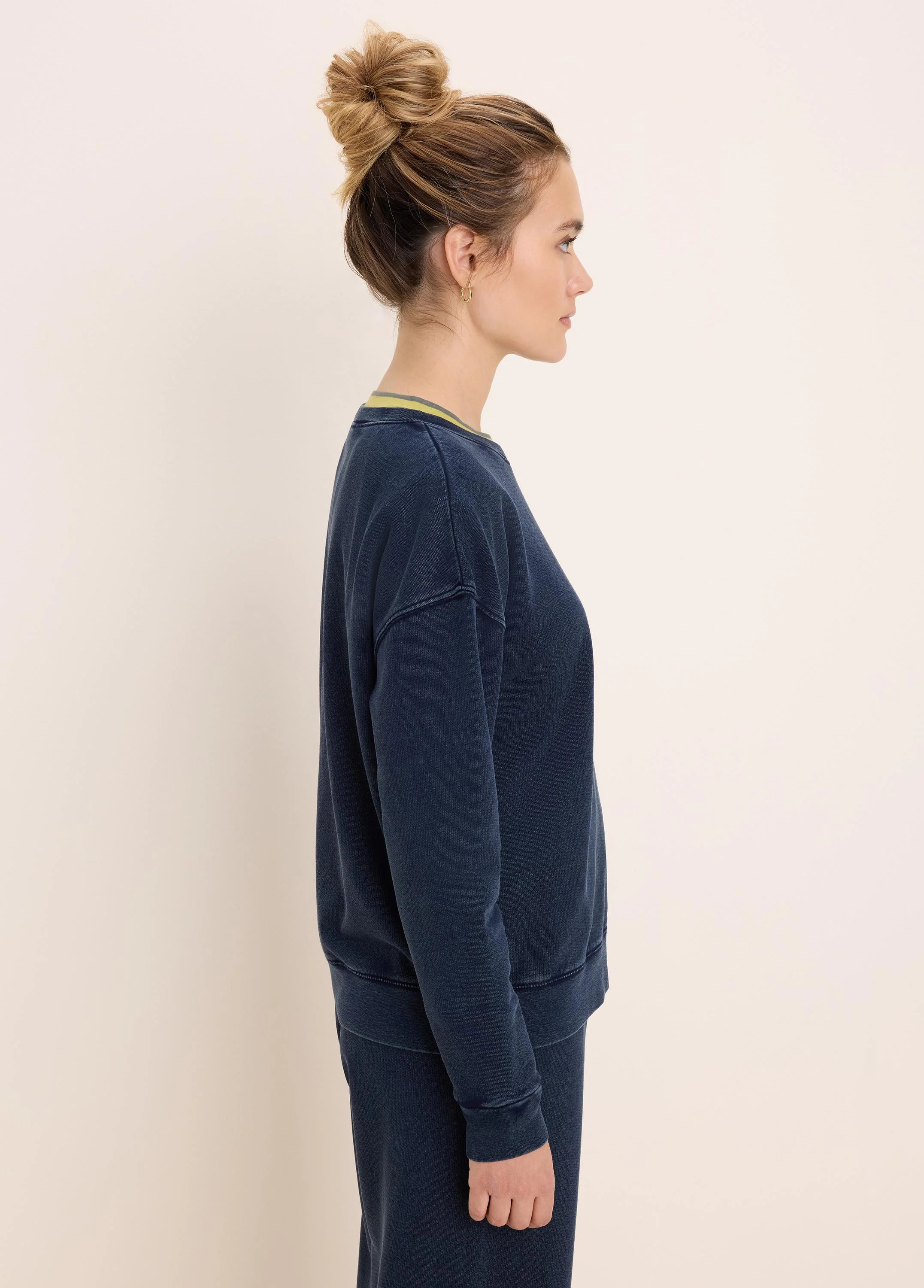 Washed dark blue cotton terry crewneck sweatshirt with a relaxed fit and green/grey striped collar.