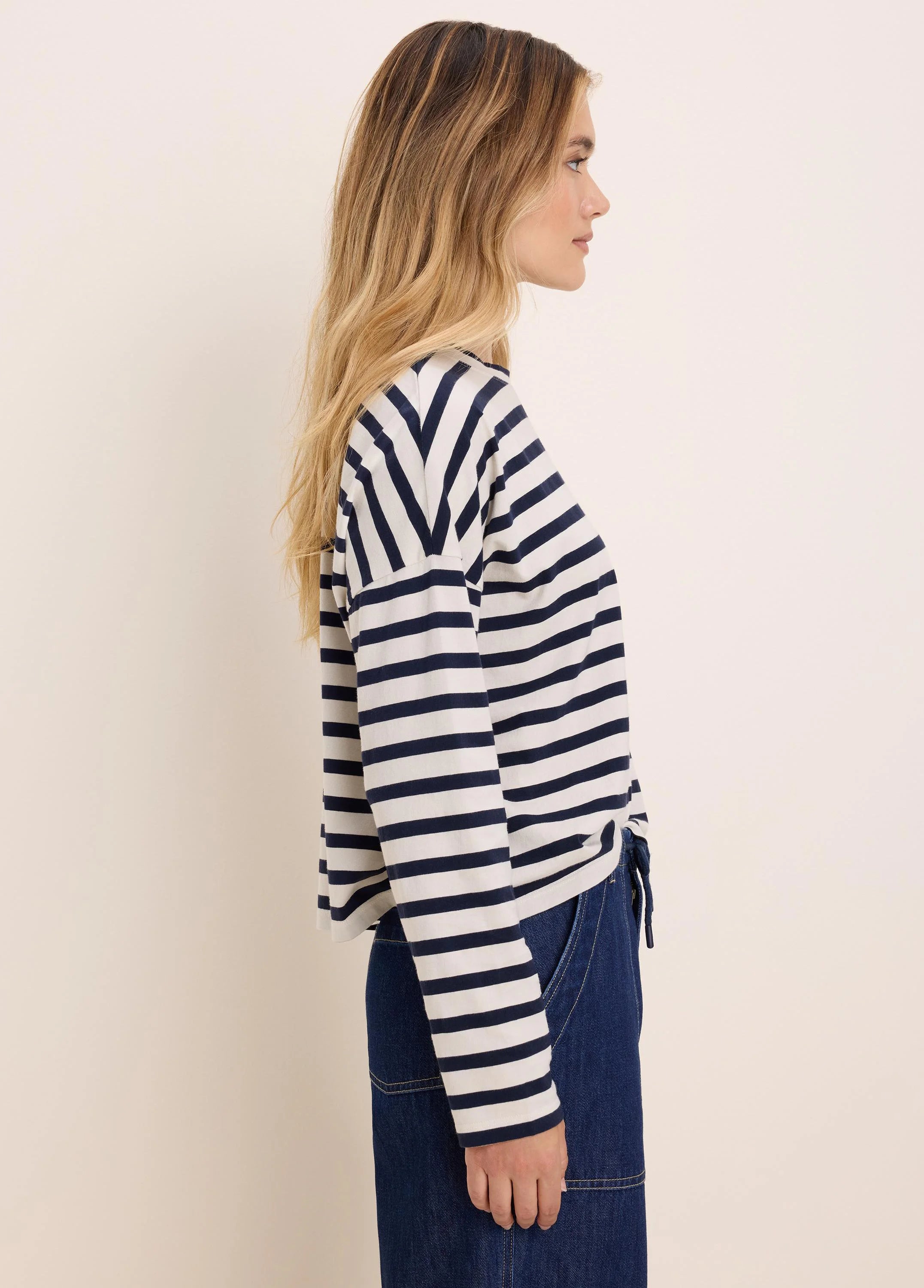 Long-sleeve tee with navy and off-white horizontal stripes, V-shaped at shoulders.