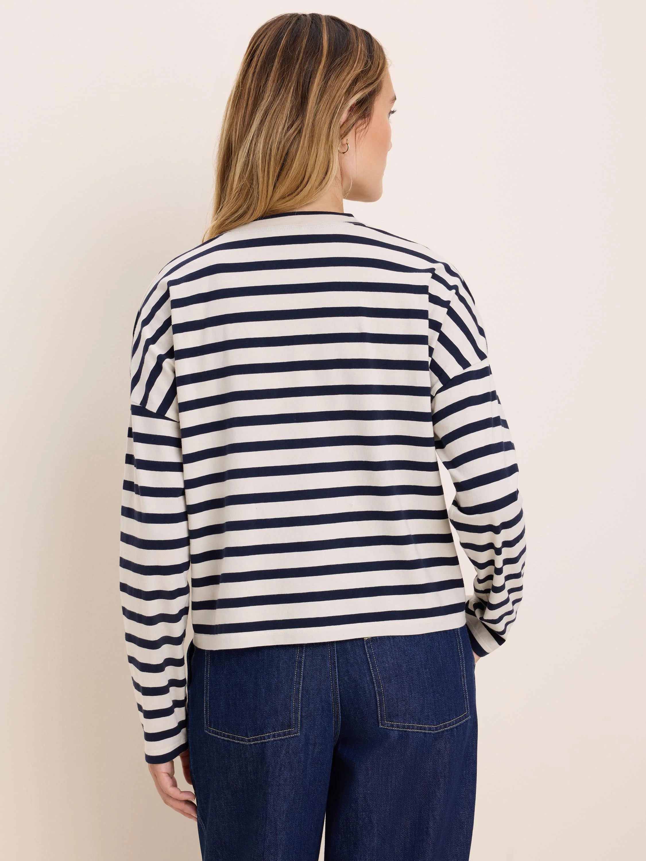 Cream and navy long-sleeve tee with horizontal stripes, relaxed fit.