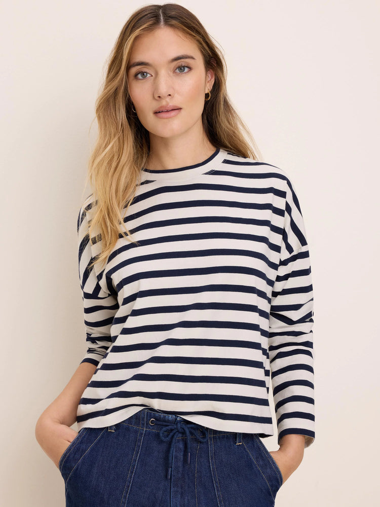 Cream long-sleeve tee with horizontal navy stripes and a crew neck.